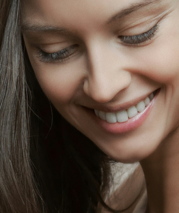 A lady smiling after having had cosmetic dentistry procedures